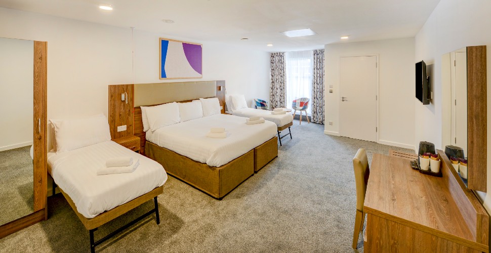 Quad room at Oyo Plymouth central, with double bed and two single beds